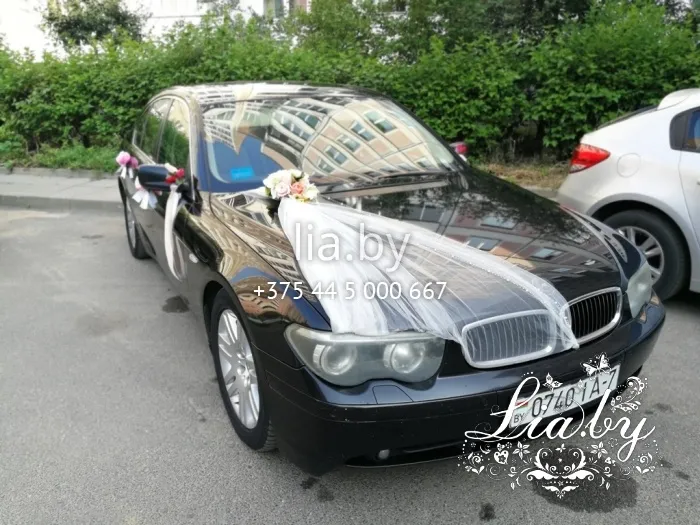 Украшение черного автомобиля на свадьбу фатином и цветами