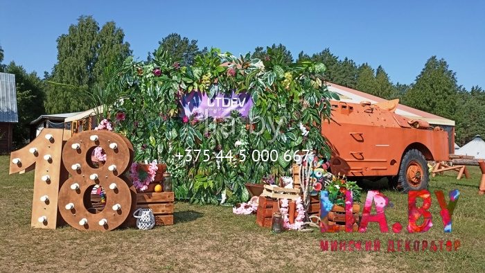 Фотозона из зелени с деревянными декорациями на корпоратив в Экспедиции